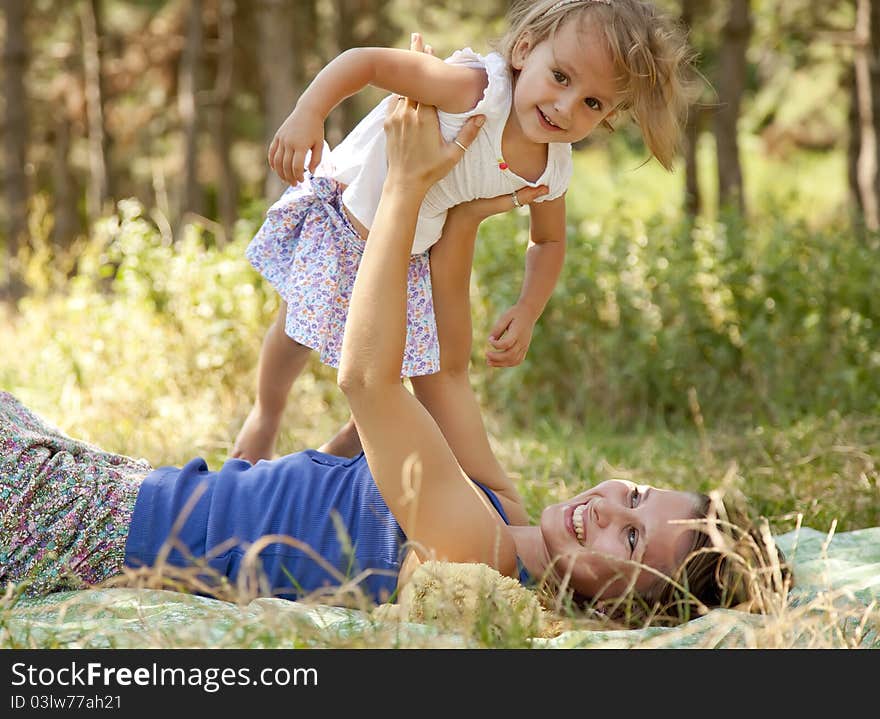 Little Girl And Mother In The Park