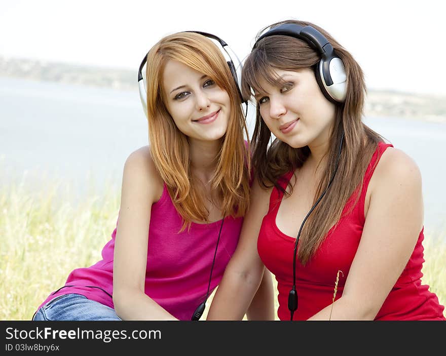 Two teenage girls listening to player.