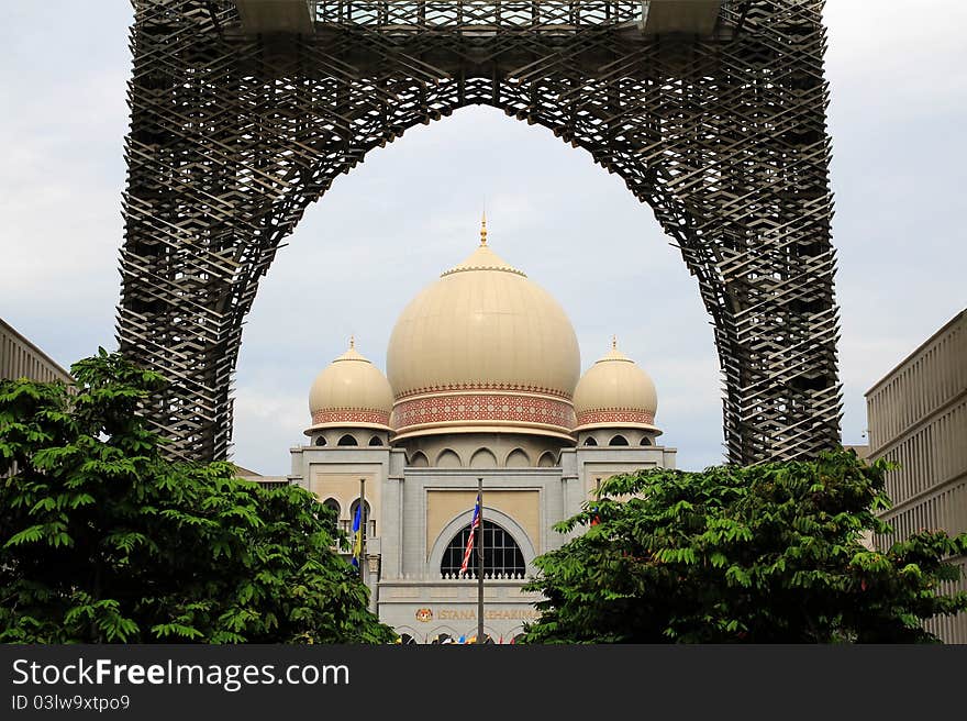 A view of the Palace Of Justice (Instana Kehakiman) @ Putrajaya shot from within the compounds of the Putrajaya Development Corporation building. The arch at the main entrance provides a natural frame to the building behind. A view of the Palace Of Justice (Instana Kehakiman) @ Putrajaya shot from within the compounds of the Putrajaya Development Corporation building. The arch at the main entrance provides a natural frame to the building behind.