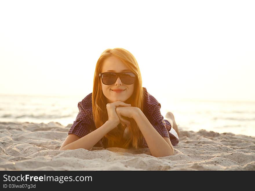 Beautiful girl with headphones at beach sand.