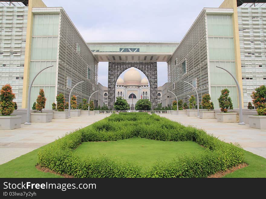 A view of the Palace Of Justice (Instana Kehakiman) @ Putrajaya shot from within the compounds of the Putrajaya Development Corporation building. The leading lines and the arch provides a natural frame to the subject matter. A view of the Palace Of Justice (Instana Kehakiman) @ Putrajaya shot from within the compounds of the Putrajaya Development Corporation building. The leading lines and the arch provides a natural frame to the subject matter.