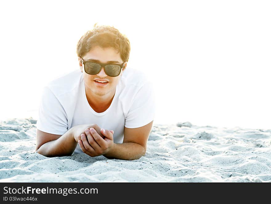 Beautiful brunette men at the beach in sunrise time. Beautiful brunette men at the beach in sunrise time