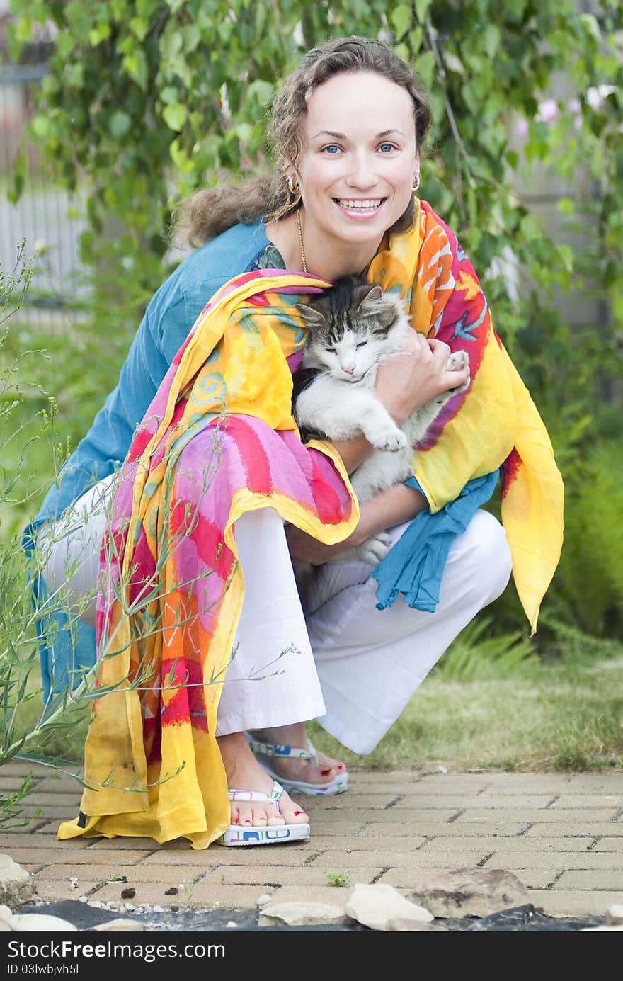 Happy woman holding fluffy cat in her hands. Happy woman holding fluffy cat in her hands