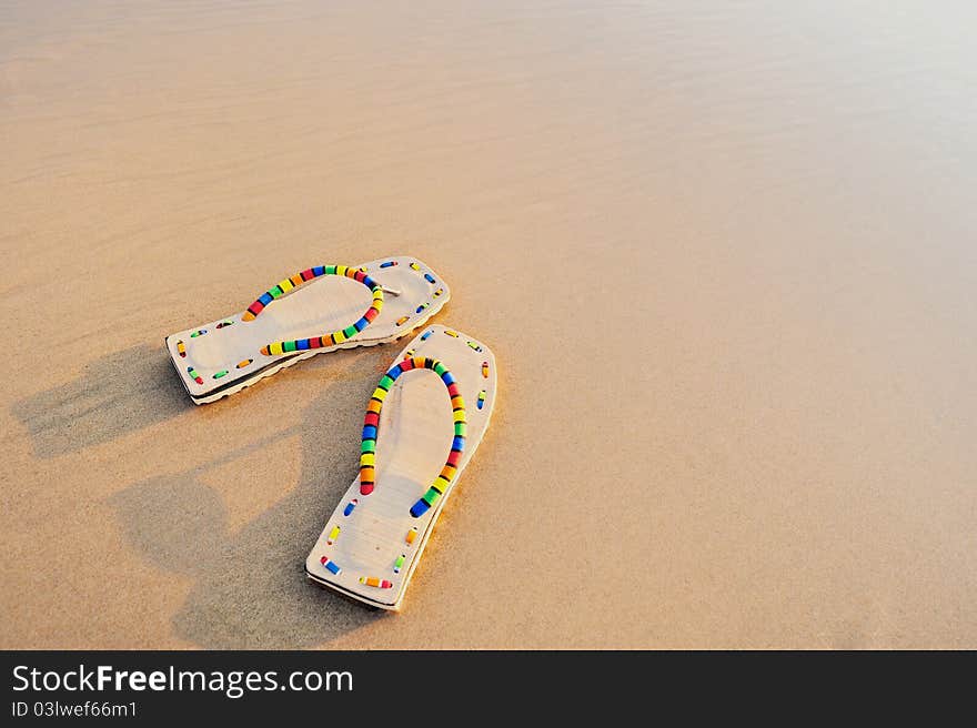 Beach sandals on the sandy sea coast. Beach sandals on the sandy sea coast