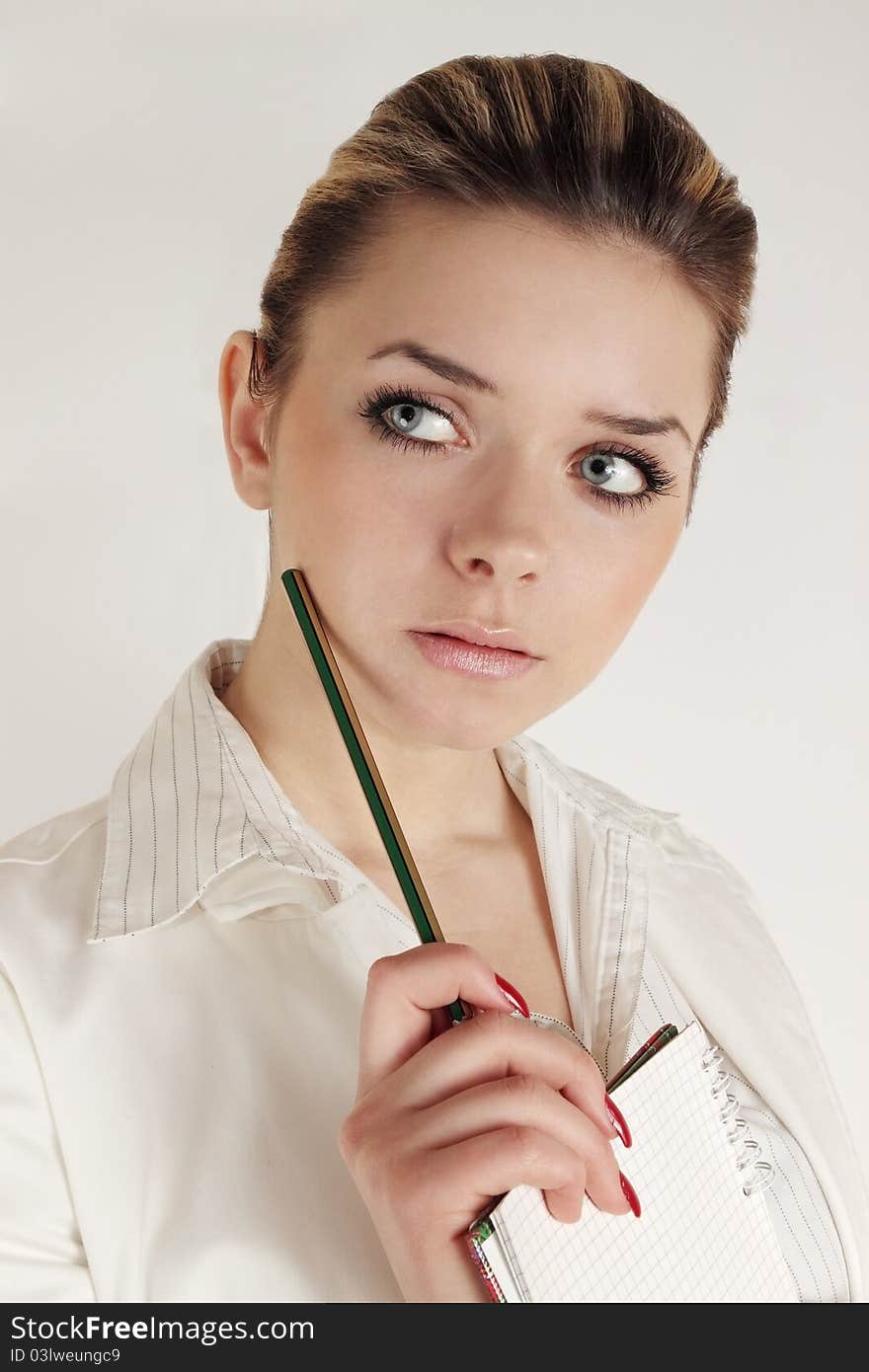 Pensive woman holds notebook in the hands