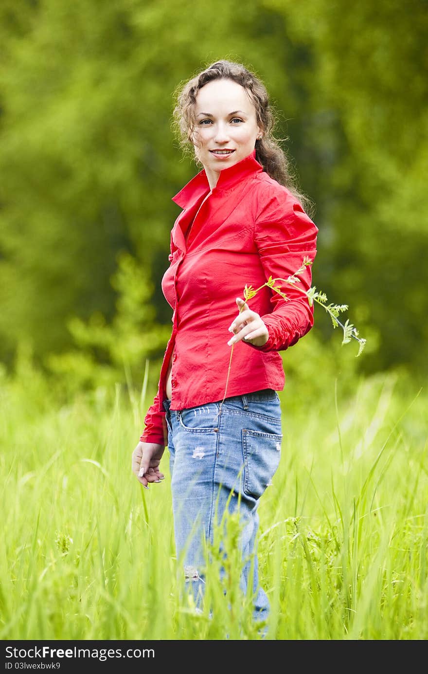 Portrait of beautiful woman against green lawn