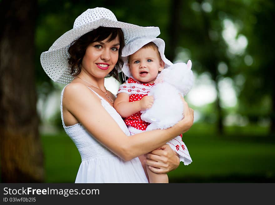 Beautiful young mother and her daughter in the park