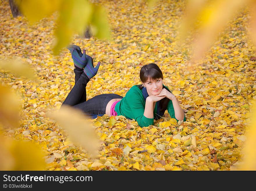 Girl  Resting On Yellow Autumn Leaves