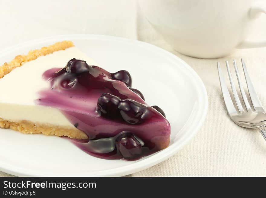 Blueberry cheese pie with coffee cup