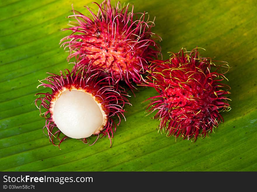 Rambutan on green banana leaf. Rambutan on green banana leaf