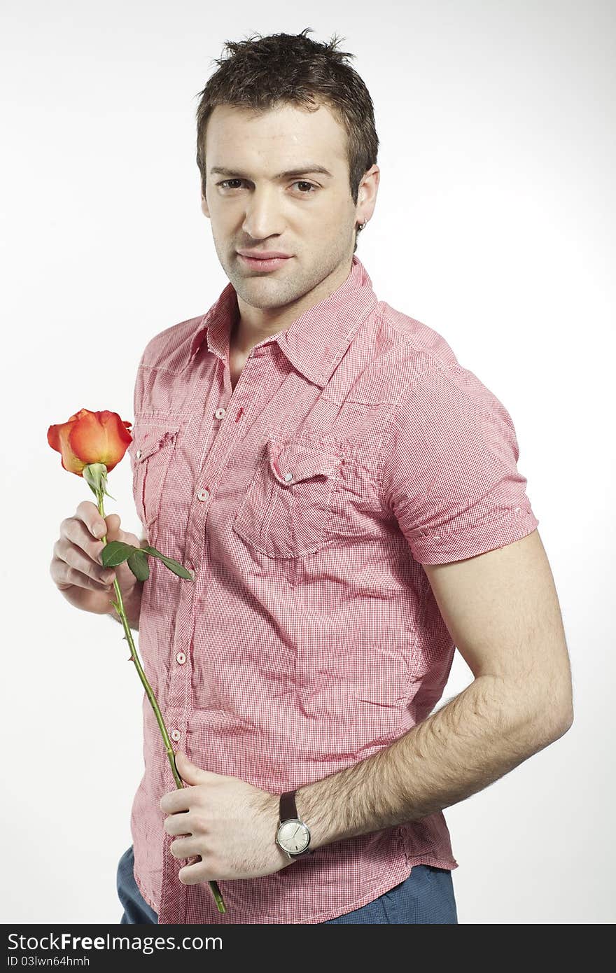 Romantic young man holding a rose