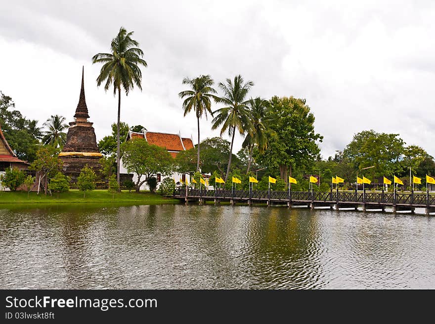 Wooden bridge to ruin pagoda cross river in Sukhothai