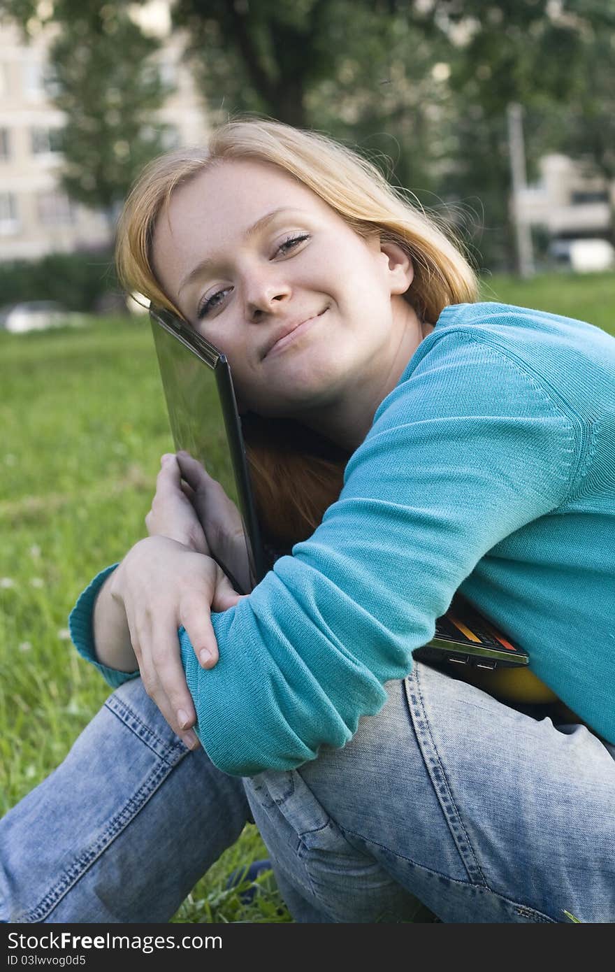 Pretty Woman With Laptop On The Green Grass