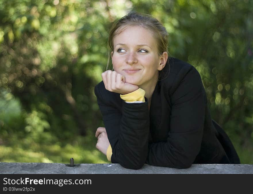 Pretty girl relaxing outdoor, on green floral background