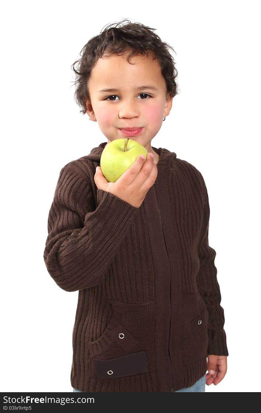 Little boy holding a golden apple while chewing. Little boy holding a golden apple while chewing