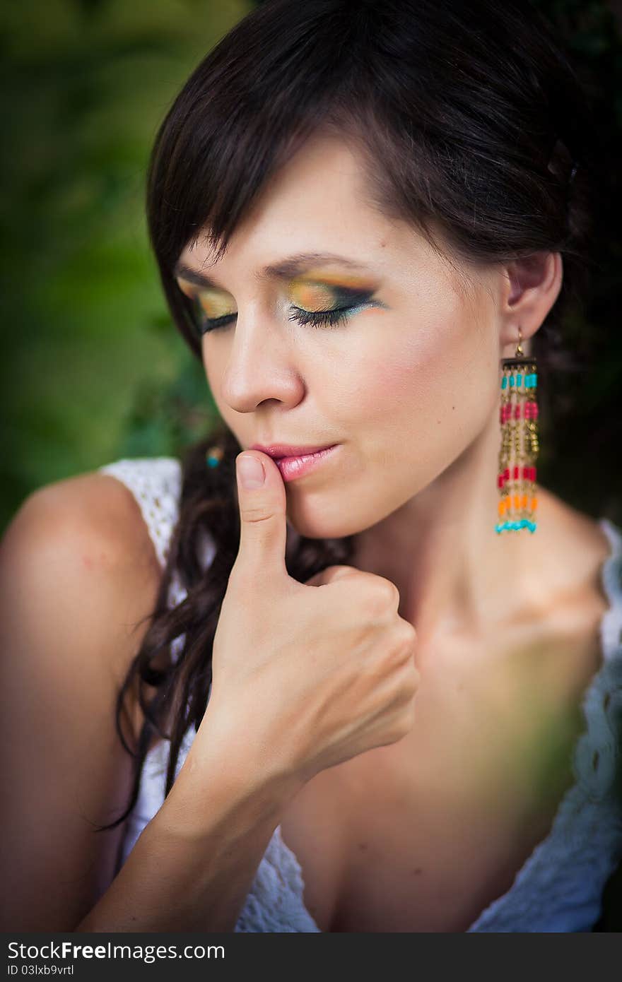 Portrait of the young beautiful woman outdoors