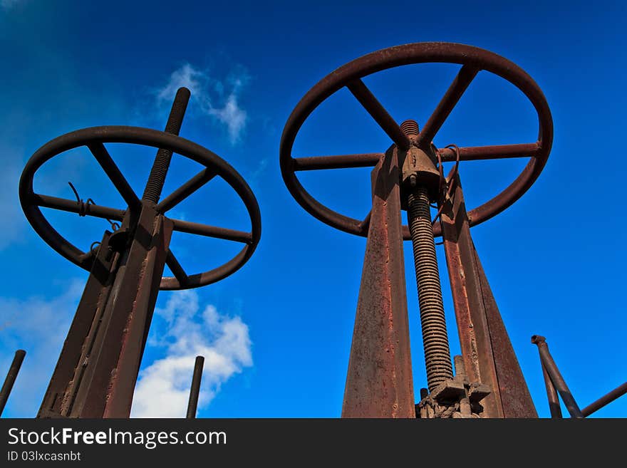 Rusty pipes valves against the clear sky. Rusty pipes valves against the clear sky