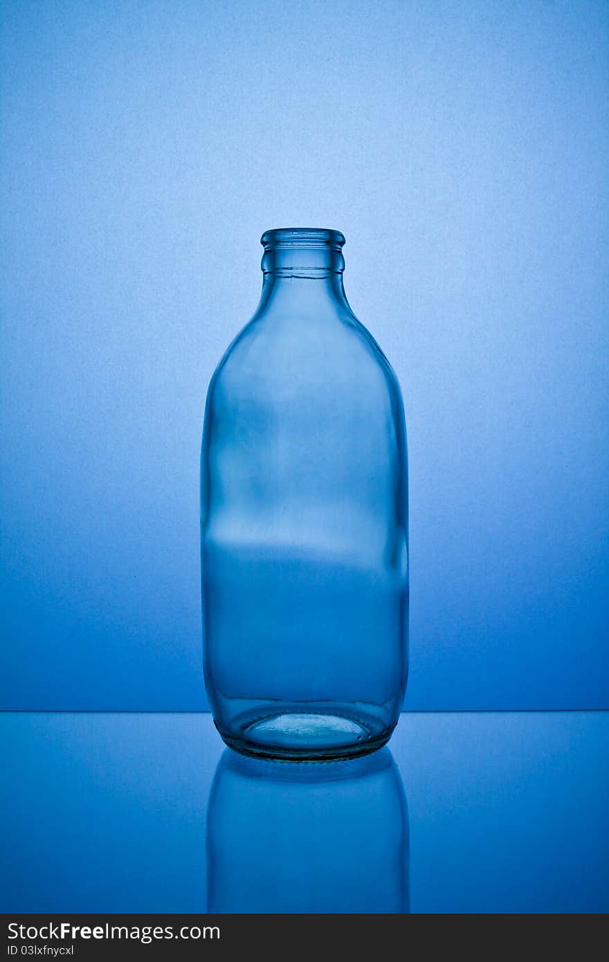 Empty bottle isolated on blue background