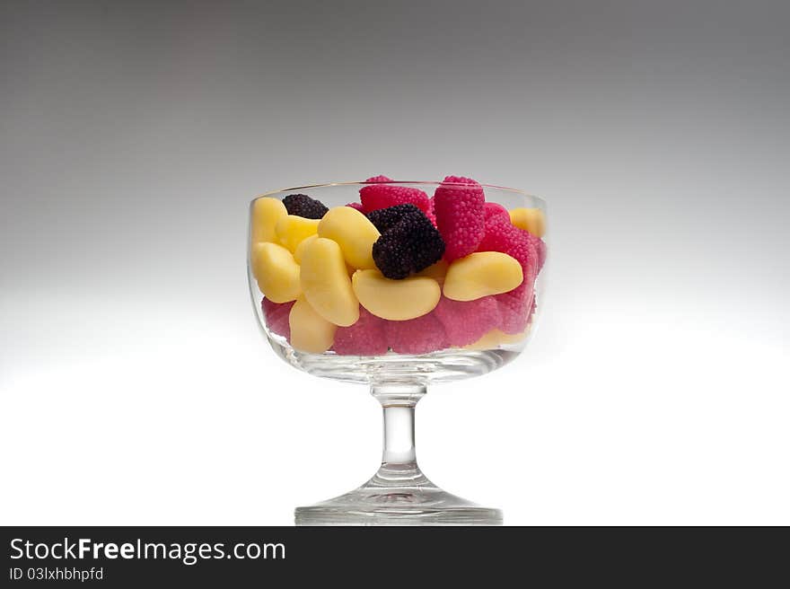 Jelly beans in a glass on gradient background