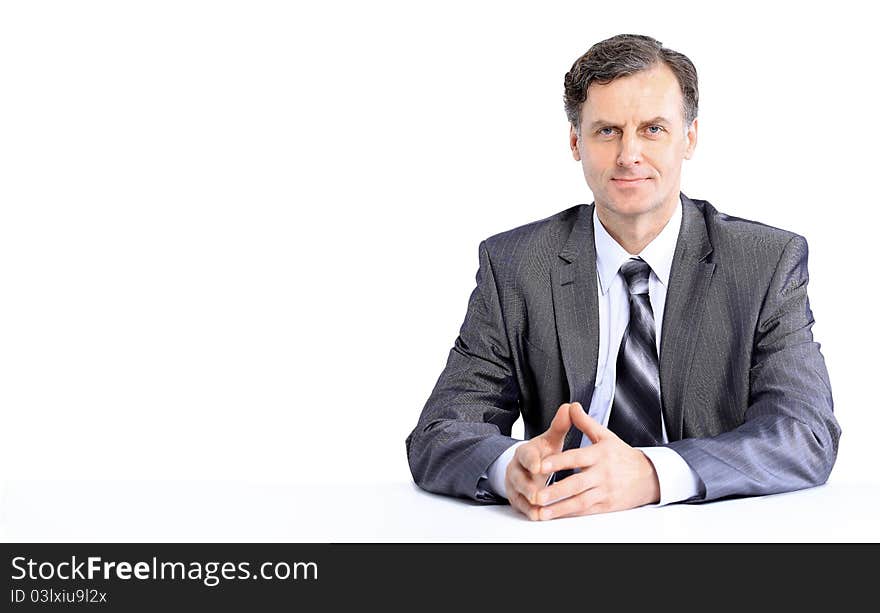 Young business man on a desk, isolated on white. Young business man on a desk, isolated on white