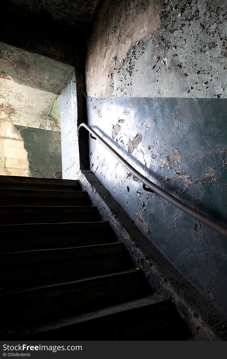 Inside the old pit head frame of coalmine Belgium in Waterschei, Limburg early morning. A doorway with peeling old paint, beautiful light. Inside the old pit head frame of coalmine Belgium in Waterschei, Limburg early morning. A doorway with peeling old paint, beautiful light