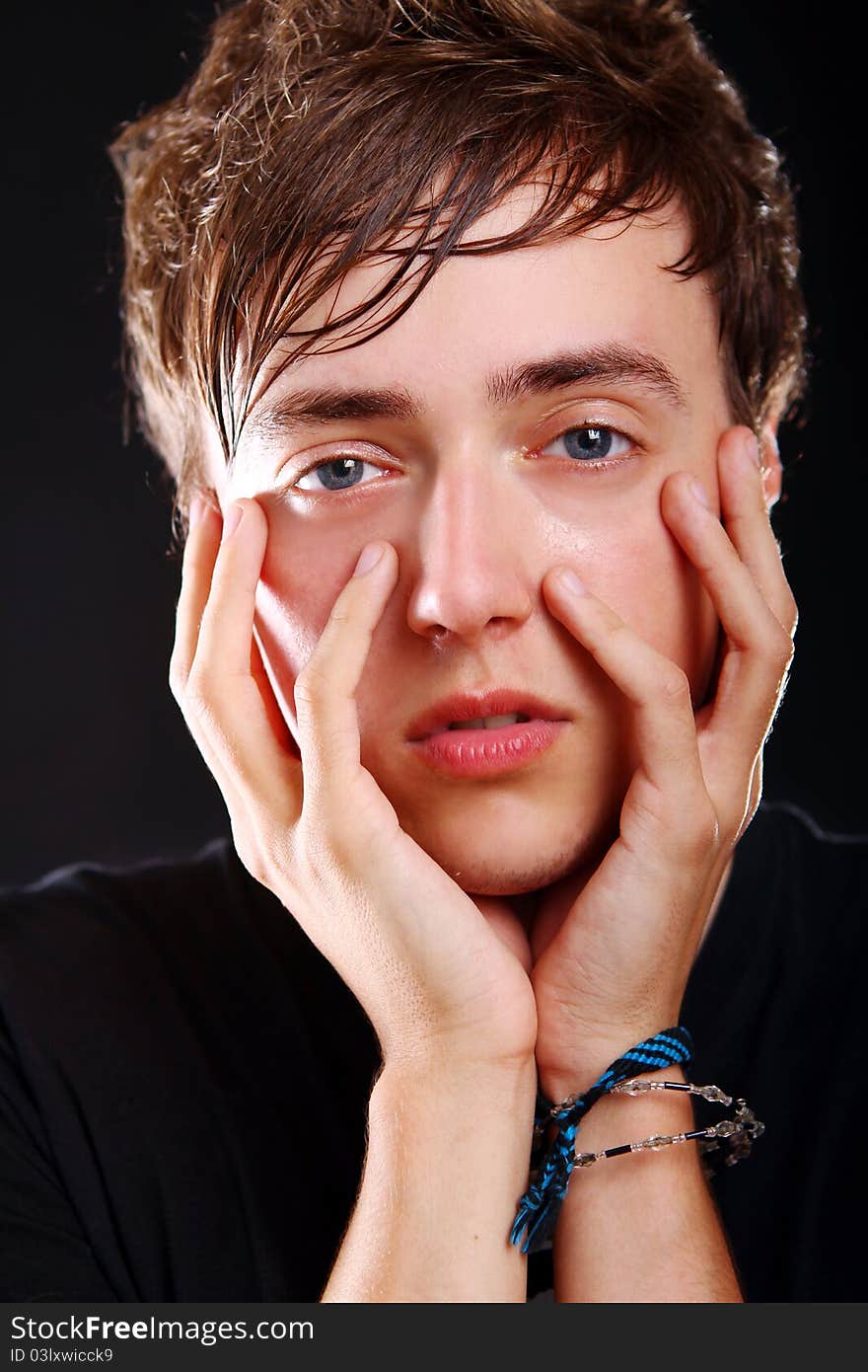 Young and attractive guy on black background