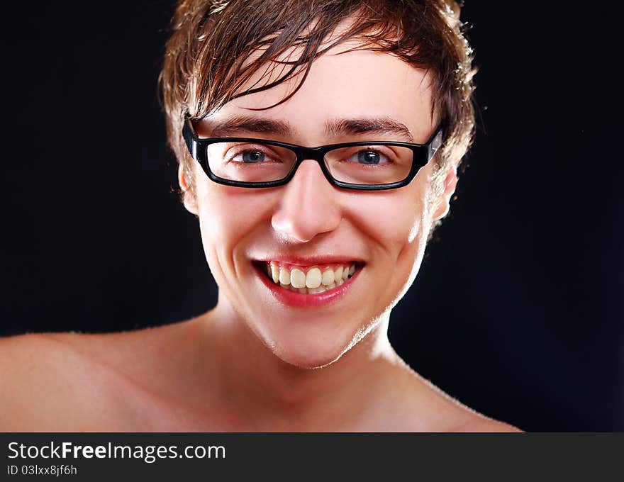 Young and attractive guy with smile on black background. Young and attractive guy with smile on black background