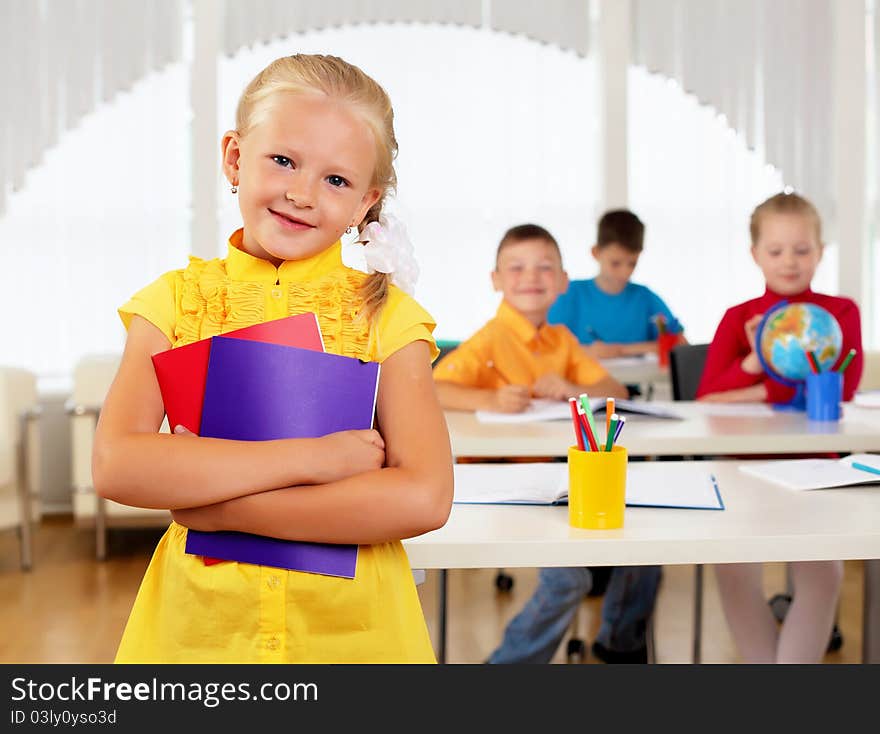 Portrait of a schoolgirl being in a classroom at school.