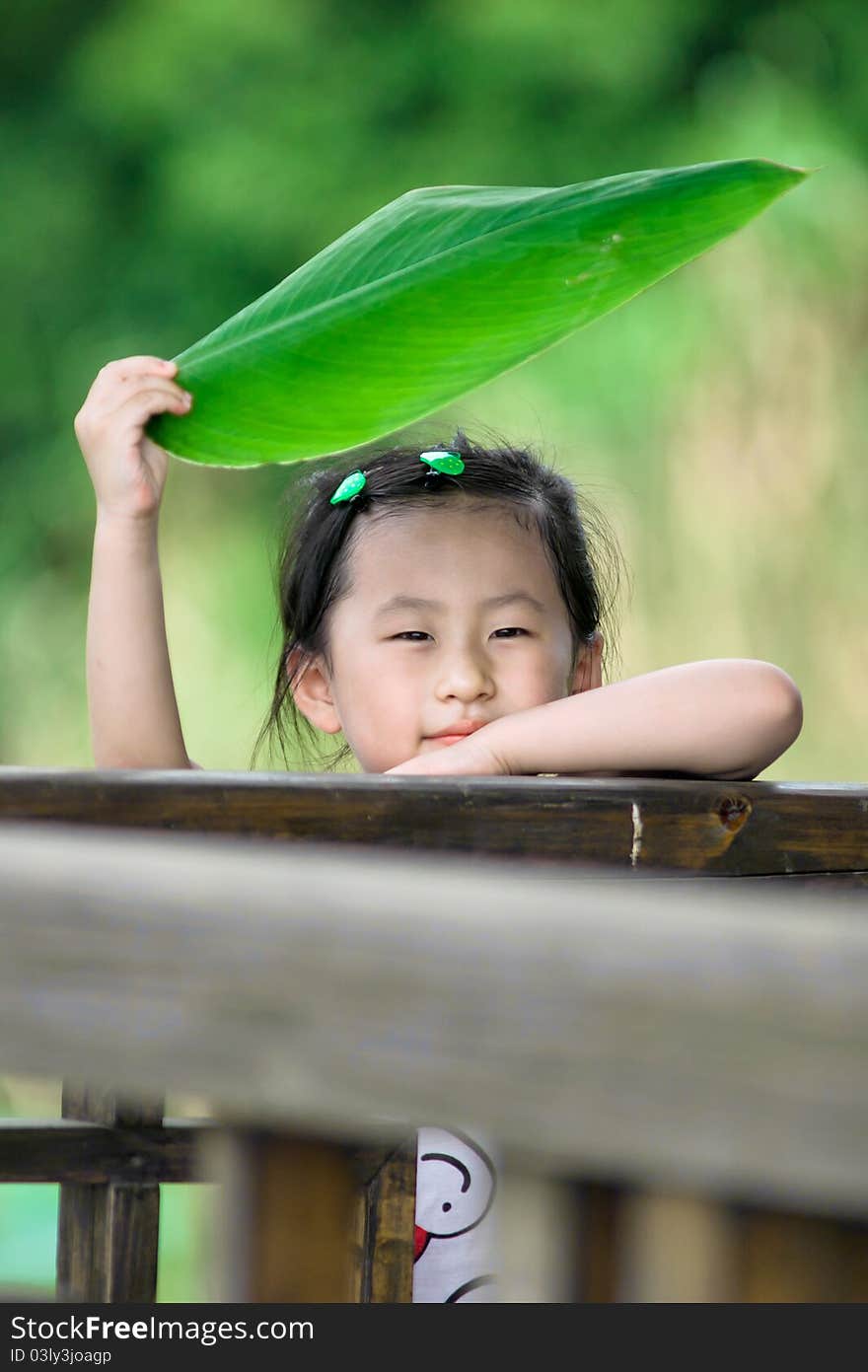 Chinese girl with lotus leaf hat