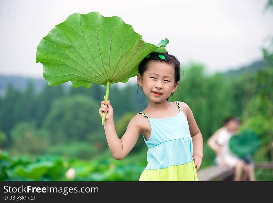 Chinese girl with lotus leaf hat