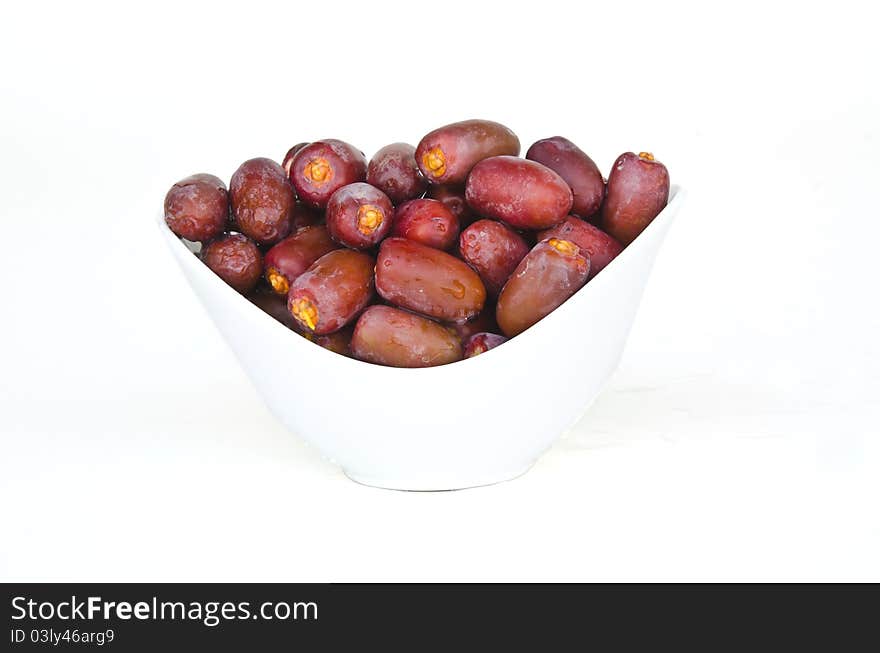 Plate full with Fresh red date fruits on white