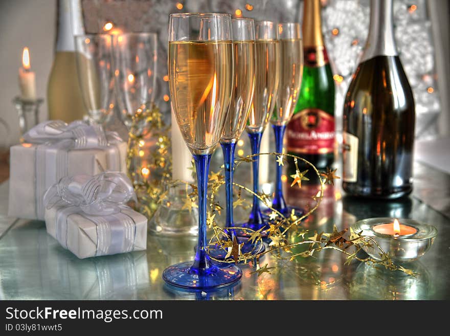 Champagne in glasses, gift boxes and lights