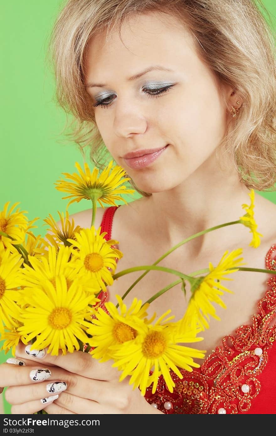 Blonde with the yellow flowers on green background. Blonde with the yellow flowers on green background