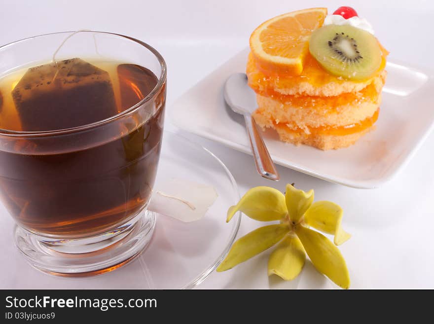 Tea and cake on white background