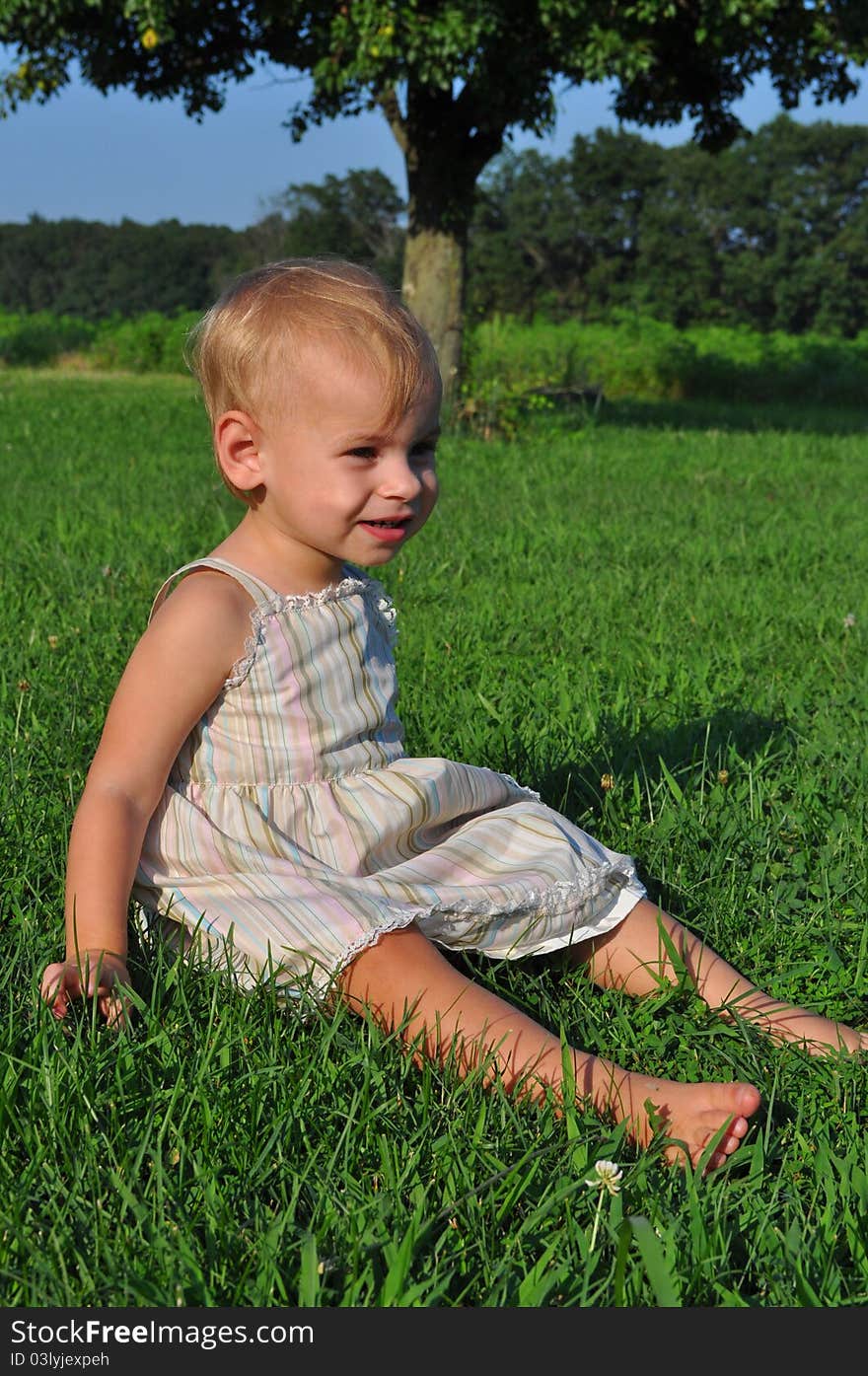 Color photograph of a baby sitting and smiling. Color photograph of a baby sitting and smiling