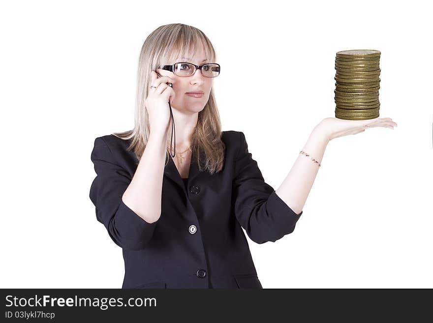 Pretty woman talking on the phone holding gold coins. Pretty woman talking on the phone holding gold coins