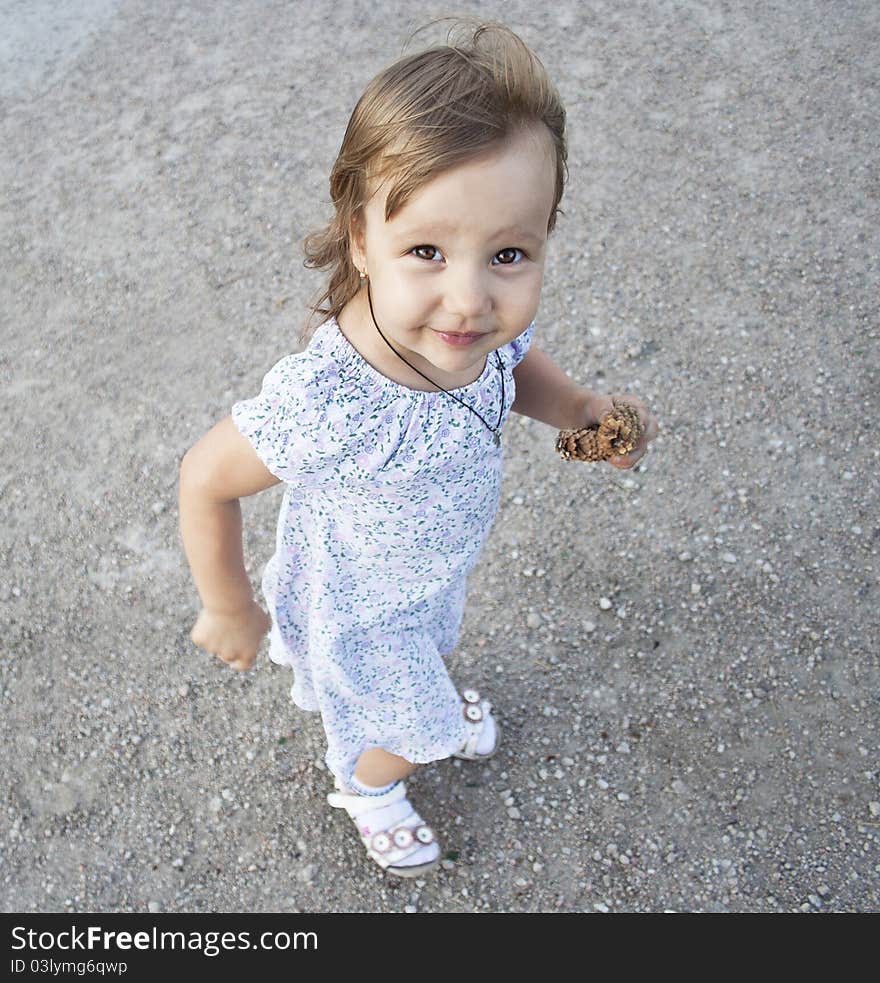 Portrait of blonde little girl outdoors in summer