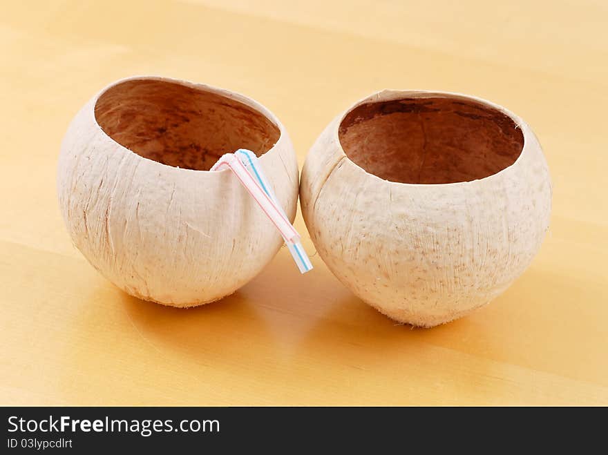 Coconut Cups With Straws On Wood