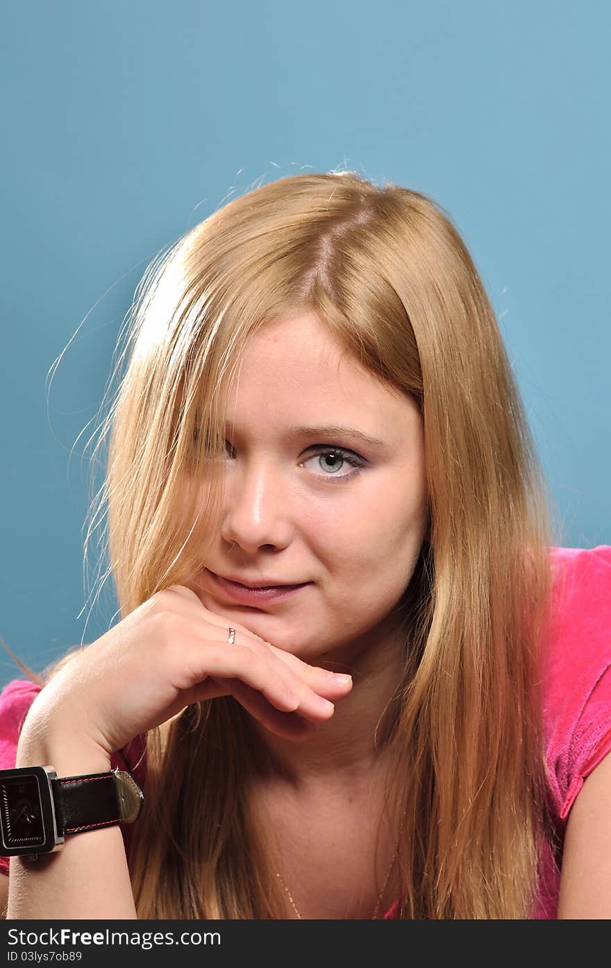 Young woman with blond hair looking friendly into the camera. Young woman with blond hair looking friendly into the camera