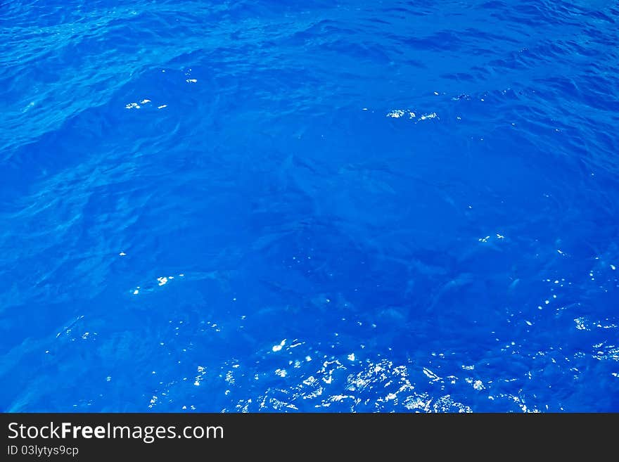 Blue Caribbean Sea Background with Sun Reflections