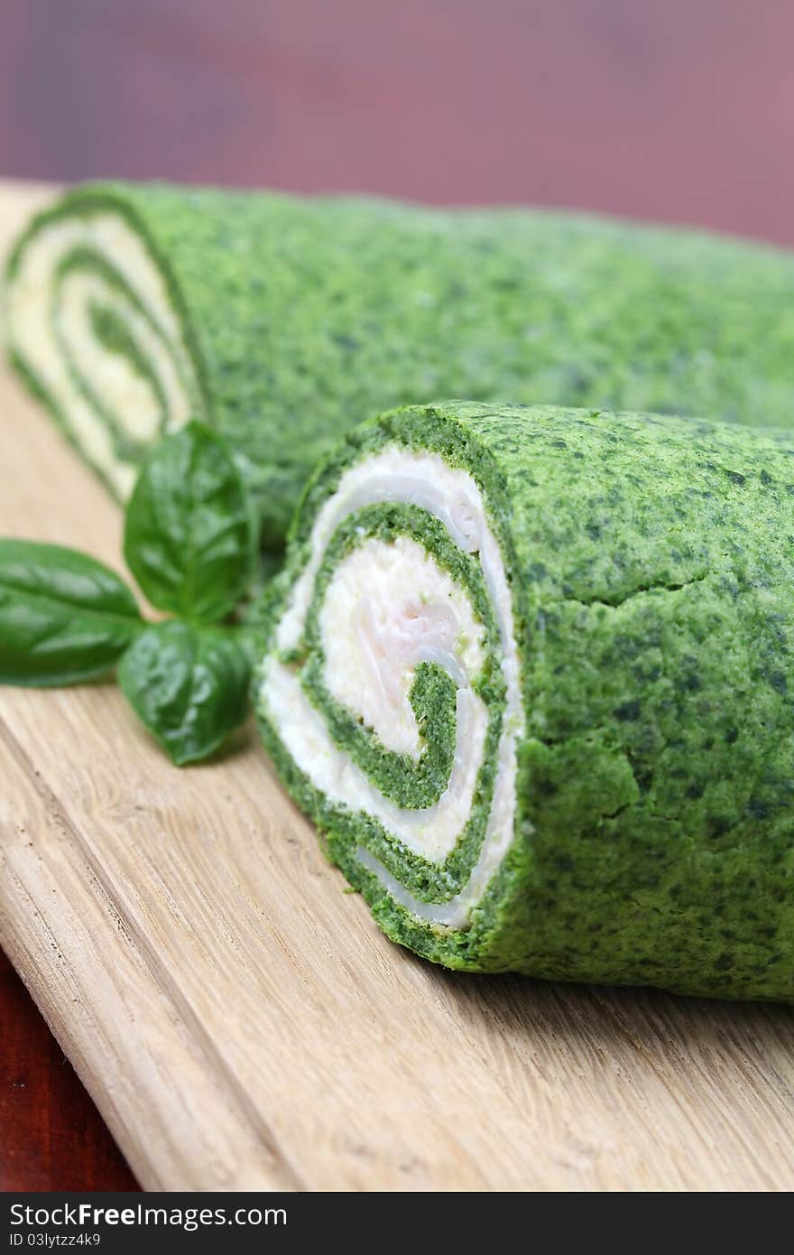 Gourmet spinach rolls, one with eggs and cheese, second one with garlic cheese and ham. Shallow dof