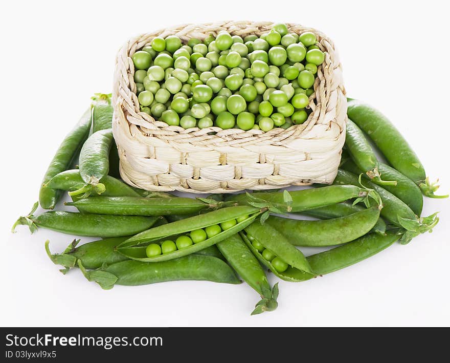 Wood basket with green peas the isolated. Wood basket with green peas the isolated