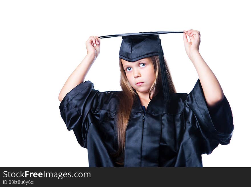 Portrait of cute serious girl in black academic cap with liripipe and gown on isolated white. Portrait of cute serious girl in black academic cap with liripipe and gown on isolated white