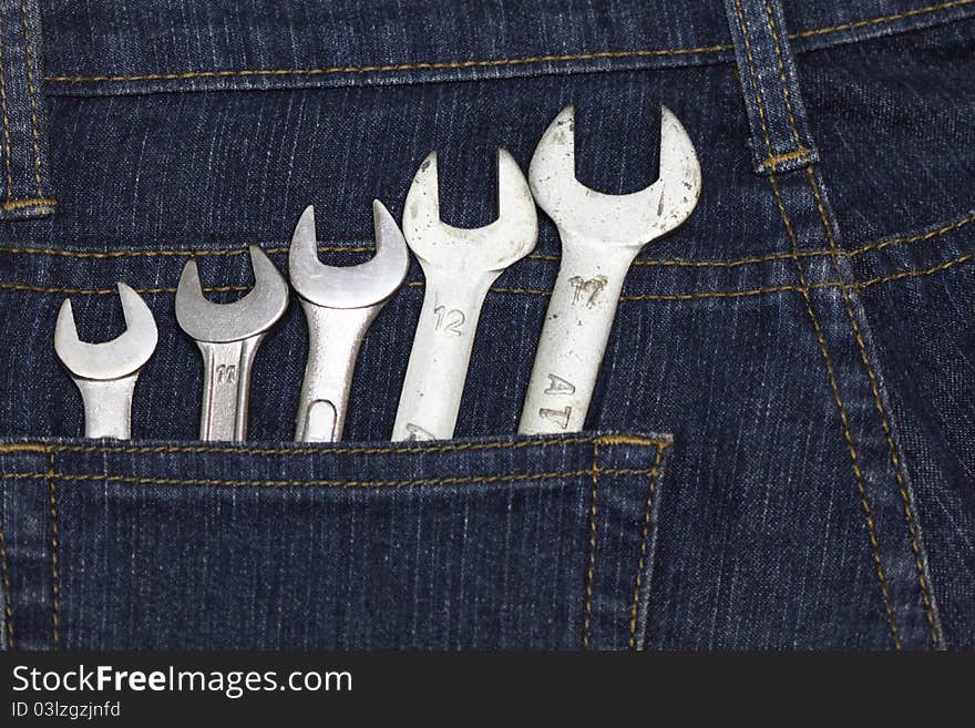 Many size of wrenches on jean. Many size of wrenches on jean