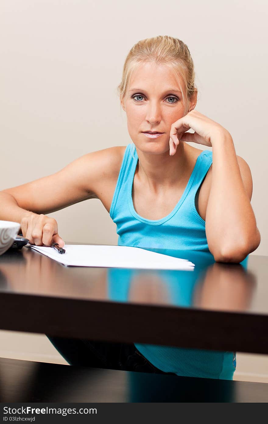 Young pretty student works on her essay at home