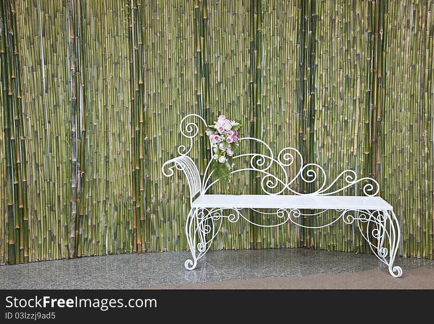 Bamboo wall and white bench