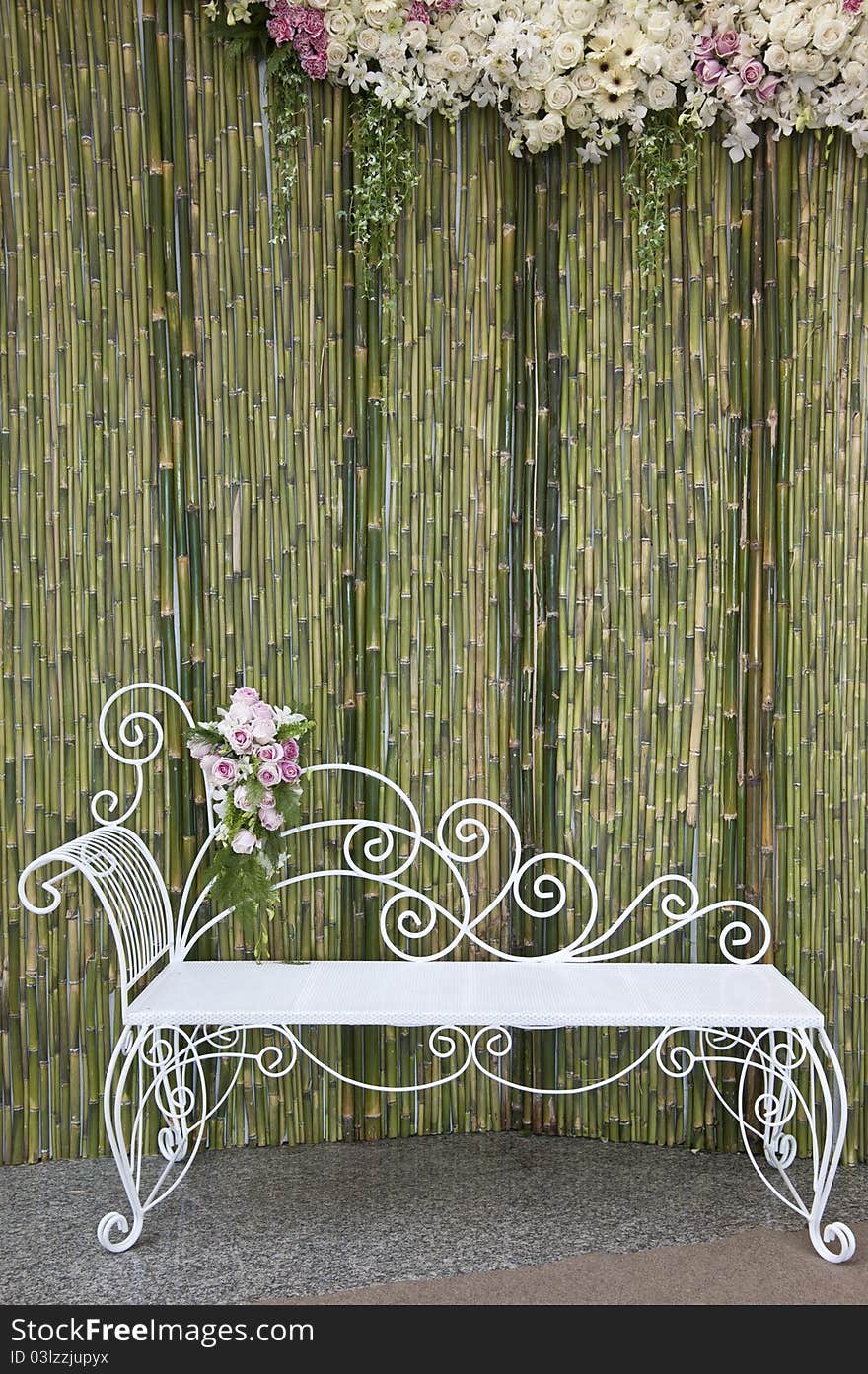 Bamboo wall with white bench