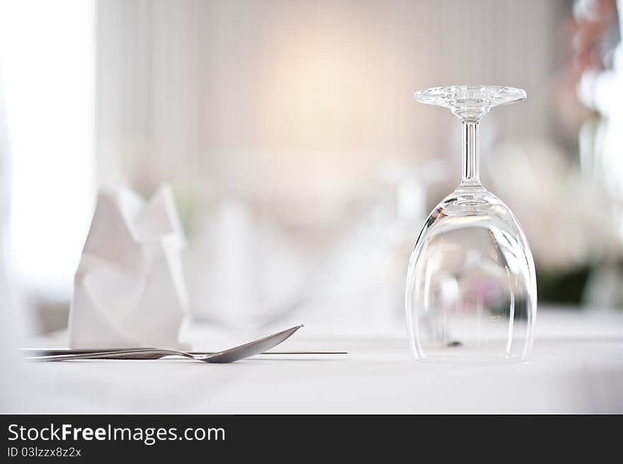 Glass goblets on white table