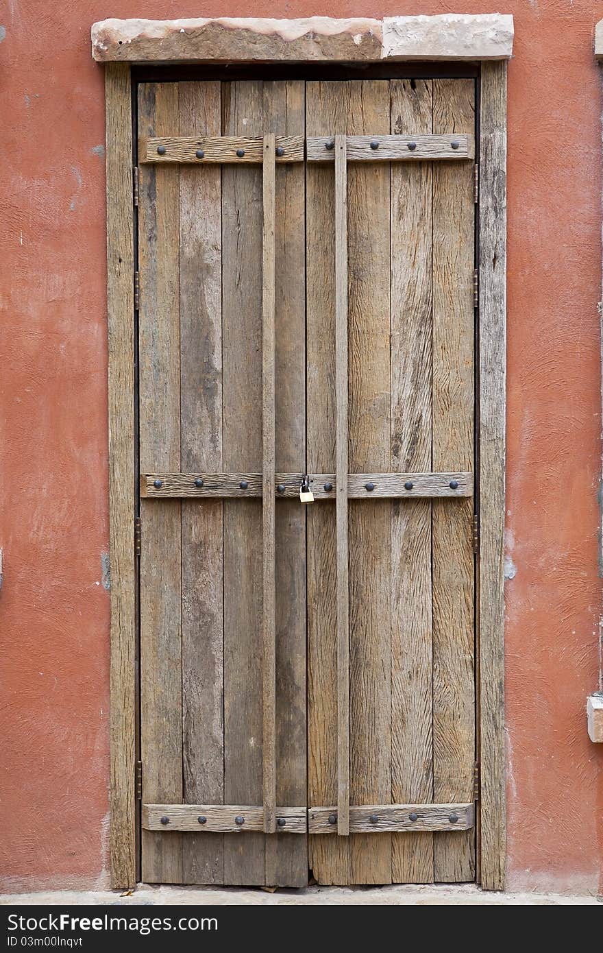 Antique wood door and orange wall