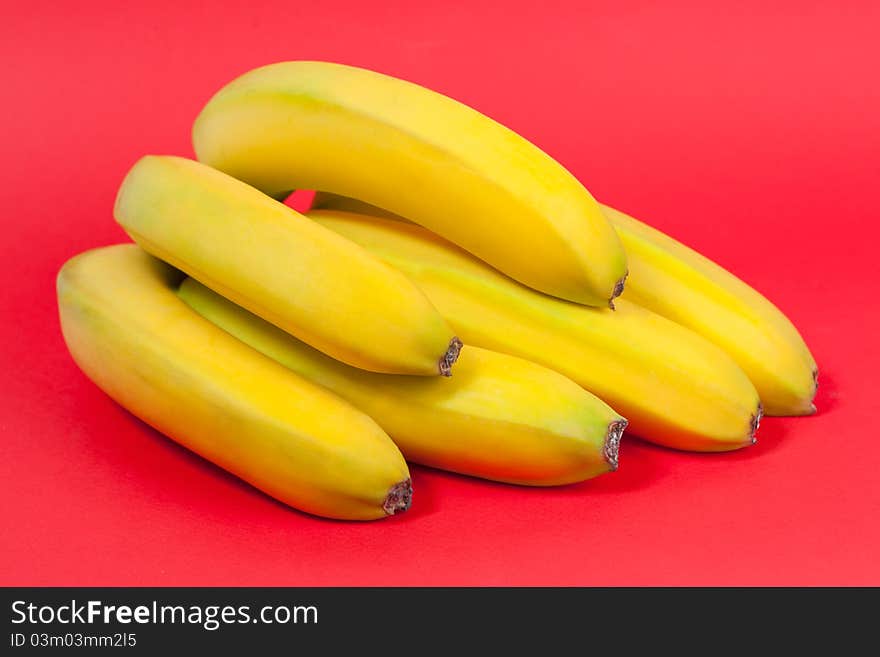 Bunch of bananas on red background